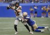 BC Lions quarterback Nathan Rourke (12) gets wrapped up by Winnipeg Blue Bombers' Willie Jefferson (5) during first half CFL action in Winnipeg Thursday, June 12, 2025. THE CANADIAN PRESS/John Woods