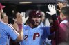 Philadelphia Phillies' Kyle Schwarber reacts after hitting a two-run home run against Atlanta Braves pitcher Austin Cox during the fourth inning of a baseball game Thursday, Aug. 28, 2025, in Philadelphia. (AP Photo/Matt Slocum)