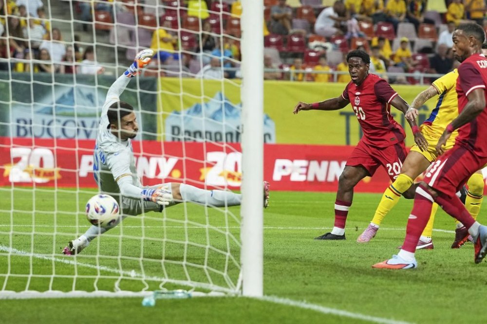 Canada's Jonathan David scores his side's first goal during an international friendly soccer match between Romania and Canada at the National Arena stadium in Bucharest, Romania, Friday, Sept. 5, 2025. (AP Photo/Andreea Alexandru)