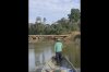 In this frame from video provided by Survival International, Dabi Nishida, of the Yine Indigenous group, maneuvers a boat near a bridge built by the company Maderera Canales Tahuamanu along the Tahuamanu River in the Peruvian Amazon’s Mashco Piro territory near the Nueva Oceania village on Aug. 18, 2025. (Courtesy of Survival International via AP)
