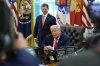 President Donald Trump speaks with reporters as Social Security Commissioner Frank Bisignano listens during an event in the Oval Office to mark the 90th anniversary of the Social Security Act, Thursday, Aug. 14, 2025, in Washington. (AP Photo/Alex Brandon)