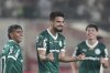 Flaco Lopez of Brazil's Palmeiras, center, celebrates after scoring his side's fourth goal against Peru's Universitario de Deportes during a Copa Libertadores round of sixteen first leg soccer match at Monumental stadium in Lima, Peru, Thursday, Aug. 14, 2025. (AP Photo/Martin Mejia)