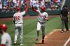 Philadelphia Phillies' Alec Bohm, right, celebrates his three-run home run with third base coach Dusty Wathan (62) as he rounds the bases during the second inning of a baseball game against the Washington Nationals, Sunday, Aug. 17, 2025, in Washington. (AP Photo/Nick Wass)