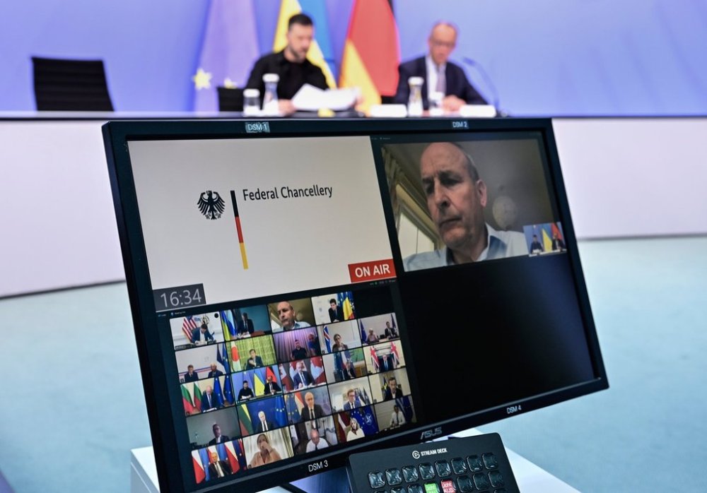 Ukrainian President Volodymyr Zelenskyy, left, and German Chancellor Friedrich Merz attend a video meeting of world leaders with Prime Minister Mark Carney and U.S. President Donald Trump on the Ukraine war in Berlin on Wednesday, Aug. 13, 2025, ahead of the summit between the U.S. and Russian leaders. (John MacDougall/Pool Photo via AP)