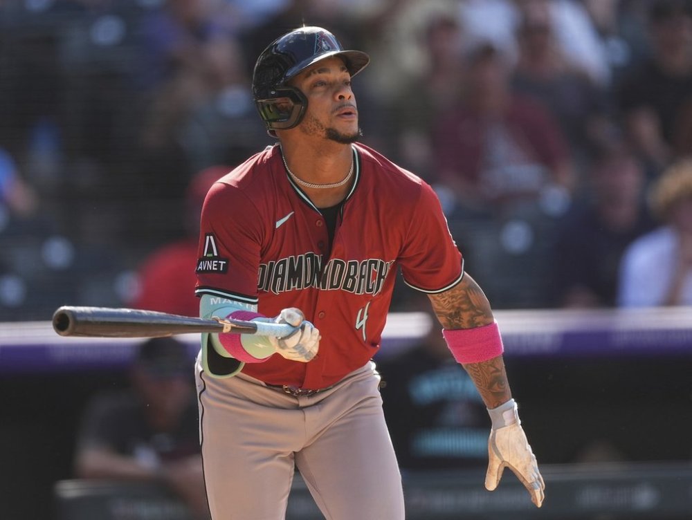 Arizona Diamondbacks' Ketel Marte pops out to Colorado Rockies relief pitcher Juan Mejia to end a baseball game Sunday, Aug. 17, 2025, in Denver. (AP Photo/David Zalubowski)