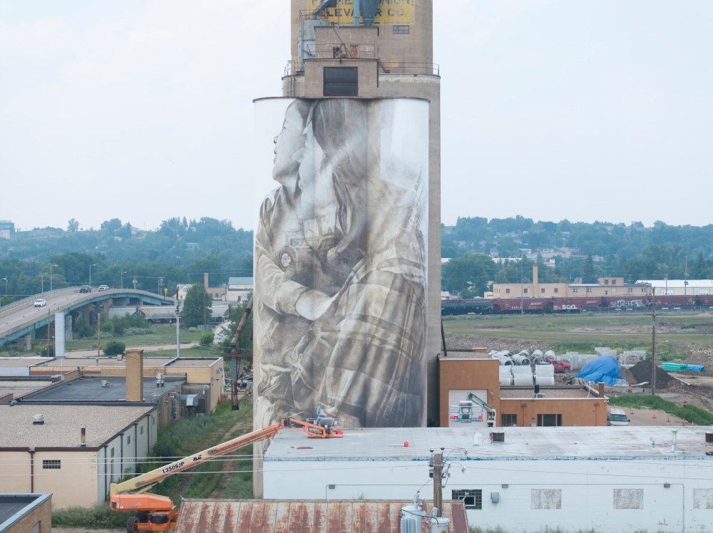 This undated photo provided by Guido van Helten shows the progress of his mural in Minot, N.D. (Guido van Helten via AP)