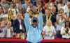 Victoria Mboko of Canada hoists the trophy following her win over Naomi Osaka of Japan during finals tennis action at the National Bank Open in Montreal, Thursday, Aug. 7, 2025. THE CANADIAN PRESS/Christinne Muschi