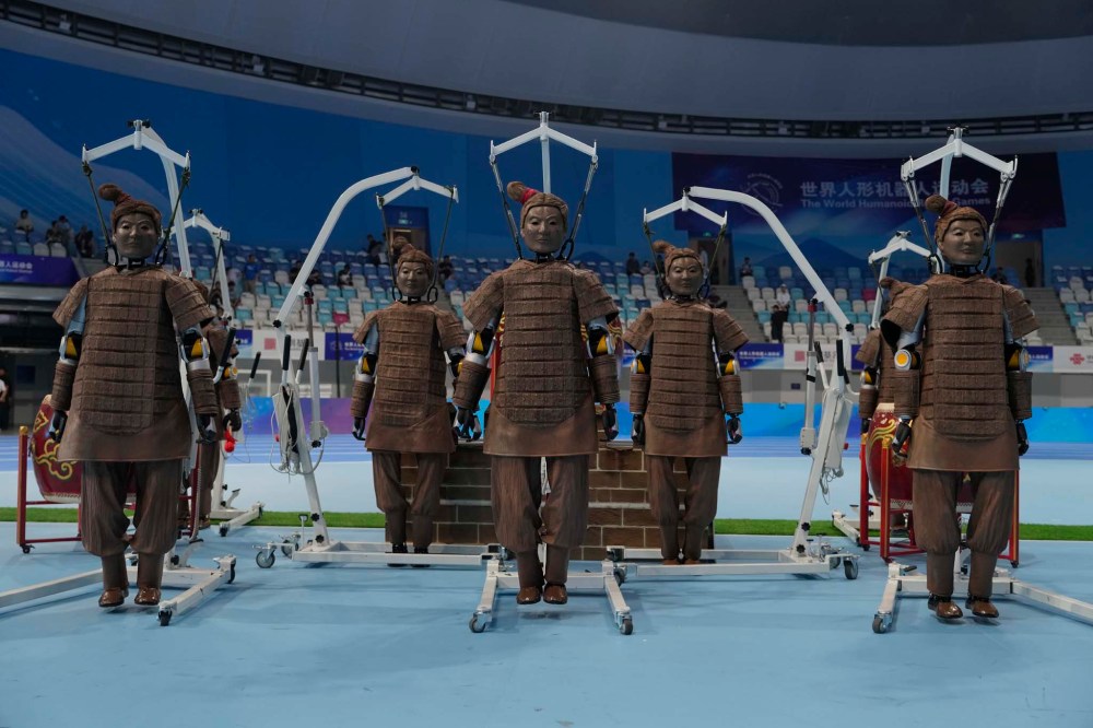 Robots dressed like terracotta warriors are setup before the opening ceremony of The World Humanoid Robot Games held in Beijing, China, Thursday, Aug. 14, 2025. (AP Photo/Ng Han Guan)