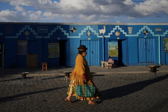 A woman walks past Aymara Indigenous spiritual workers' workplaces at El Alto, Bolivia, on Aug. 15. Natacha Pisarenko / The Associated Press files)
