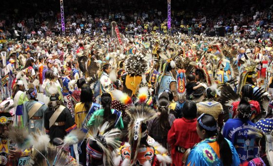 Hundreds of Indigenous dancers pour onto the floor at University of New Mexico Arena for the grand entry during the 29th Annual Gathering of Nations in Albuquerque, N.M., on April 27, 2012.  (Susan Montoya Bryan / The Associated Press files)