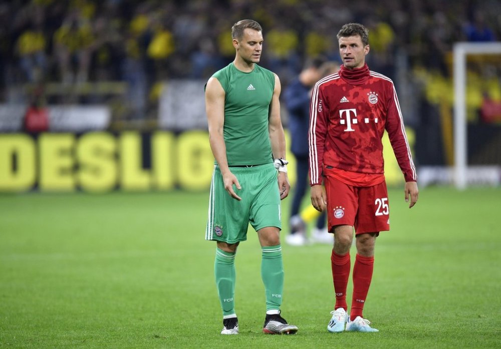 FILE - Bayern goalkeeper Manuel Neuer, left, and Bayern's Thomas Muller react after the German Supercup final soccer match between Borussia Dortmund and Bayern Munich in Dortmund, Germany, Saturday, Aug. 3, 2019. (AP Photo/Martin Meissner, file)