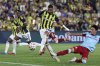 Fenerbahce's Youssef En-Nesyri, center, attempts a shot at goal against Feyenoord's Tsuyoshi Watanabe during a Champions League third qualifying round second leg soccer match between Fenerbahce and Feyenoord at the Ulker stadium, in Istanbul, Turkey, Tuesday, Aug. 12, 2025. (Huseyin Yavuz/Dia Photo via AP)