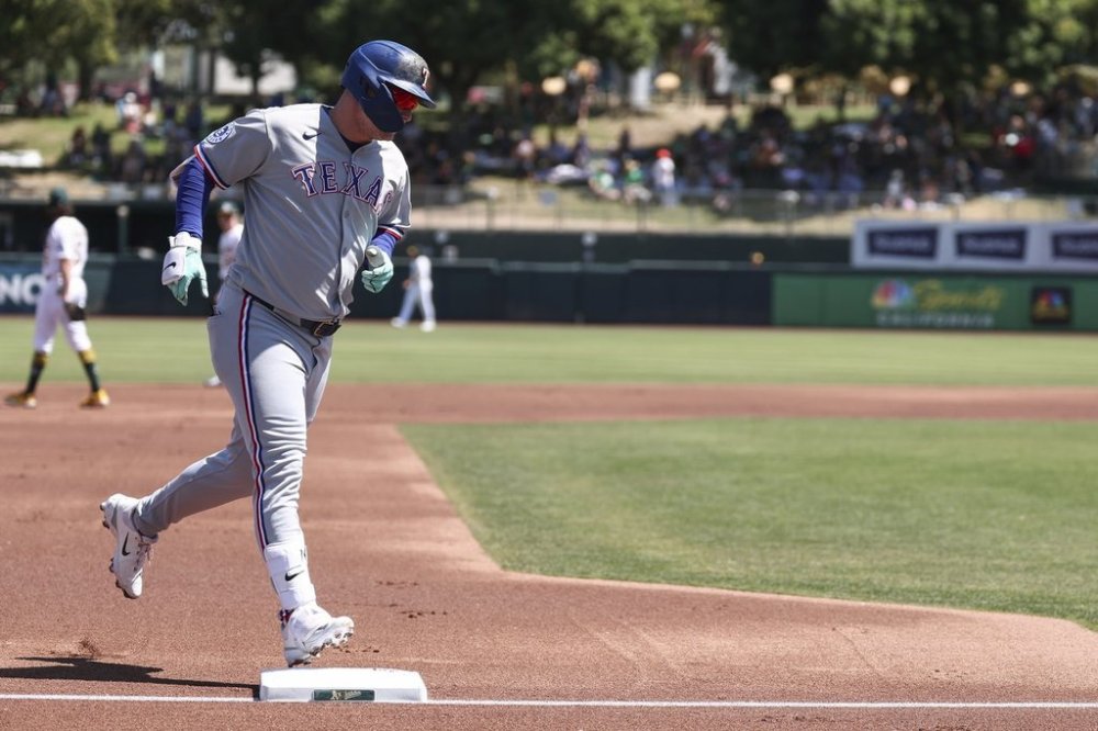 Texas Rangers' Joc Pederson runs the bases after hitting a two-run home run during the first inning of a baseball game against the Athletics, Sunday, Aug. 31, 2025, in West Sacramento, Calif. (AP Photo/Sara Nevis)
