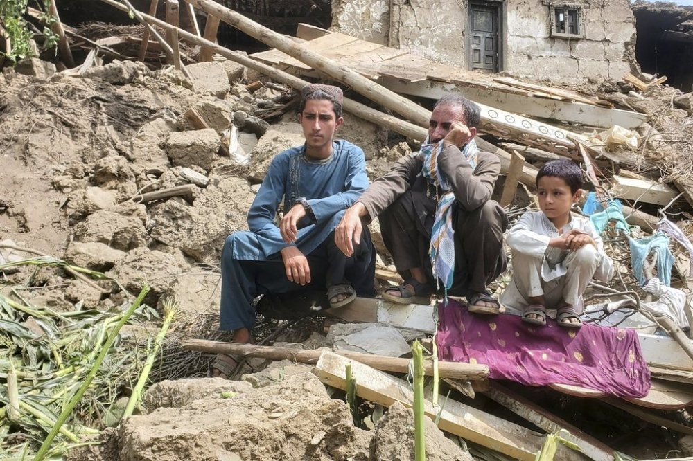 Survivors sit on rubble in Mazar Dara, Kunar province, on Tuesday, Sept. 2, 2025, as civil defence workers and army soldiers search for survivors in the wake of a powerful 6.0-magnitude earthquake that struck eastern Afghanistan on Sunday. (AP Photo/Hedayat Shah)