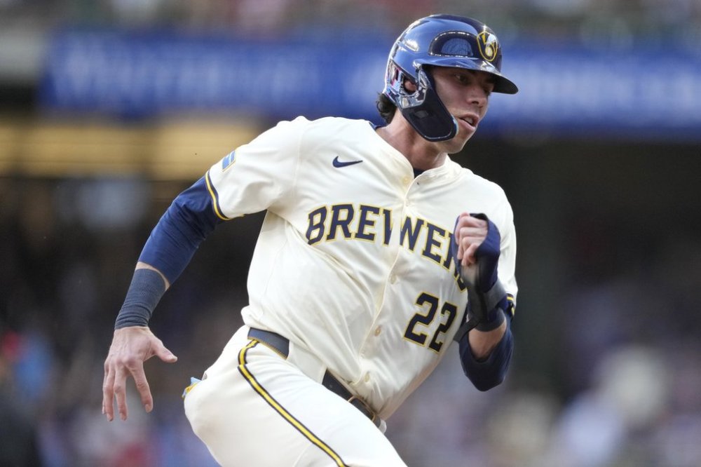 Milwaukee Brewers' Christian Yelich rounds third base on his way to scoring on a two-run RBI double hit by Blake Perkins during the first inning of a baseball game against the Philadelphia Phillies, Monday, Sept. 1, 2025, in Milwaukee. (AP Photo/Kayla Wolf)