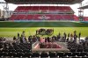Politicians and stakeholders gather around a microphone during an announcement at Toronto's BMO Field on Friday, May 3, 2024, which revealed $104 million in federal funding for Toronto to host six games during the 2026 FIFA World Cup. THE CANADIAN PRESS/Chris Young