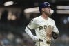 Milwaukee Brewers' Joey Ortiz blows a gum bubble as he jogs toward first base after flying out during the eighth inning of a baseball game against the Pittsburgh Pirates, Monday, Aug. 11, 2025, in Milwaukee. (AP Photo/Aaron Gash)
