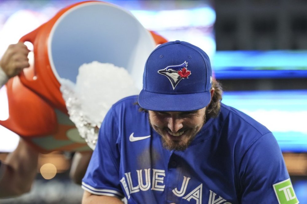 Blue Jays outfielder Addison Barger ducks away from an ice bucket thrown by teammates after defeating the Minnesota Twins in Major League Baseball action in Toronto on Wednesday, Aug. 27, 2025. THE CANADIAN PRESS/Chris Young