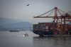 The paddle wheeler Constitution passes the container ship GSL Lydia docked at port, while sailing on the harbour as wildfire smoke hangs in the air, in Vancouver, on Thursday, Aug. 28, 2025. THE CANADIAN PRESS/Darryl Dyck