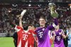 Bayern's Dayot Upamecano, left, and goalkeeper Manuel Neuer celebrate after winning the German Supercup final soccer match between VfB Stuttgart and Bayern Munich in Stuttgart, Germany, Saturday, Aug. 16, 2025. (Bernd Weissbrod/dpa via AP)