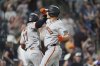 San Francisco Giants' Heliot Ramos, left, congratulates Matt Chapman as he crosses home plate after hitting a three-run home run off Colorado Rockies relief pitcher Juan Mejia in the sixth inning of a baseball game Wednesday, Sept. 3, 2025, in Denver. (AP Photo/David Zalubowski)