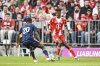 Bayern's Kingsley Coman, right, takes on Lyon's Sael Kumbedi during the test soccer match between Bayern Munich and Olympique Lyon, at the Allianz Arena in Munich, Germany, Saturday, Aug. 2, 2025. (Harry Langer/dpa via AP)