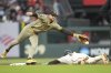 San Francisco Giants' Drew Gilbert, bottom, steals second base under San Diego Padres second baseman Jake Cronenworth during the third inning of a baseball game in San Francisco, Monday, Aug. 11, 2025. (AP Photo/Jeff Chiu)