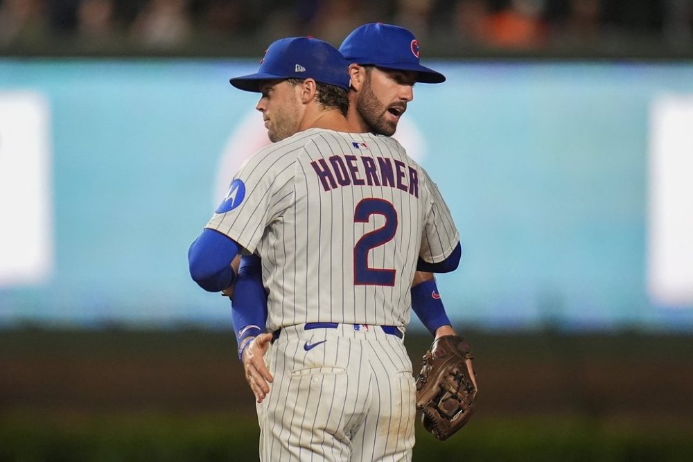 Chicago Cubs second baseman Nico Hoerner (2) and shortstop Dansby Swanson (7) celebrate their team's win over the Milwaukee Brewers in the second baseball game of a split doubleheader Tuesday, Aug. 19, 2025, in Chicago. (AP Photo/Erin Hooley)