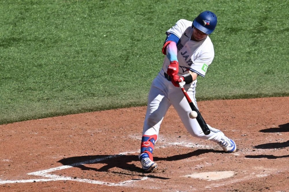 Toronto Blue Jays catcher Tyler Heineman (55) hits an RBI double against the Milwaukee Brewers in fifth inning MLB action in Toronto on Sunday, Aug. 31, 2025. THE CANADIAN PRESS/Jon Blacker