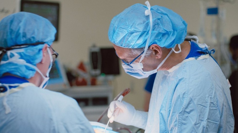 Dr. Andres Lozano, right, a neurosurgeon at University Health Network, and his surgical team at Toronto Western Hospital are shown in this handout image on Wednesday Aug. 27, 2025. THE CANADIAN PRESS/Handout - UHN / Neuralink (Mandatory Credit)