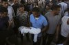 A relative carries the body of Palestinian infant Jabr Al-Ashhab, who was killed in an Israeli military strike, during his funeral outside Shifa Hospital in Gaza City, Thursday, Sept. 4, 2025. (AP Photo/Jehad Alshrafi)