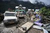 FILE - Household goods are strewn around next to buildings damaged by flash floods in Chositi village, Kishtwar district, Indian-controlled Kashmir, Aug. 15, 2025. (AP Photo/Channi Anand, File)