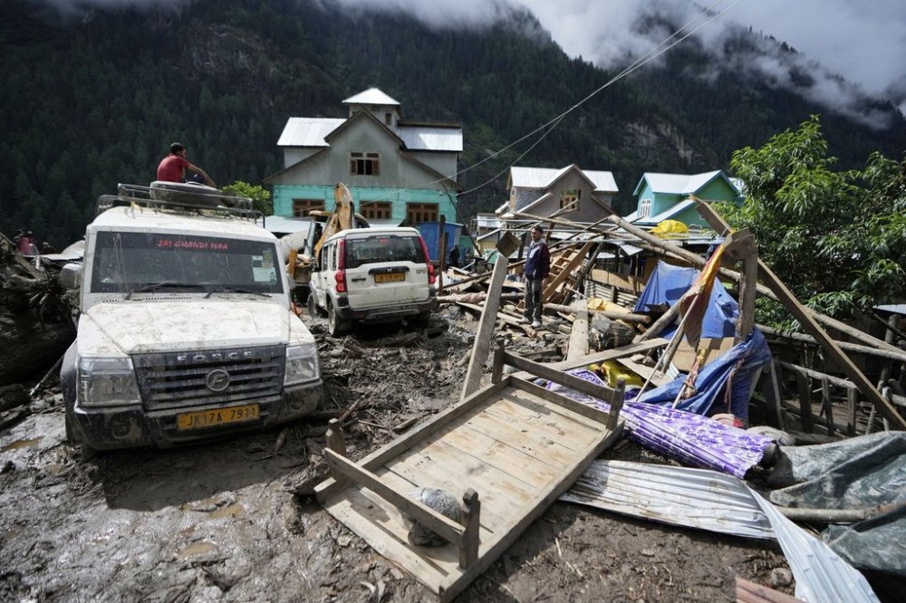 FILE - Household goods are strewn around next to buildings damaged by flash floods in Chositi village, Kishtwar district, Indian-controlled Kashmir, Aug. 15, 2025. (AP Photo/Channi Anand, File)