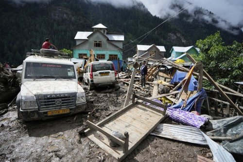 FILE - Household goods are strewn around next to buildings damaged by flash floods in Chositi village, Kishtwar district, Indian-controlled Kashmir, Aug. 15, 2025. (AP Photo/Channi Anand, File)
