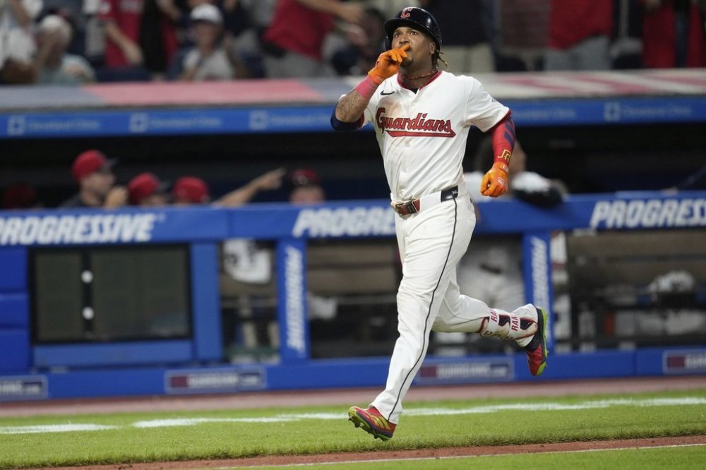 Cleveland Guardians' Jose Ramirez gestures as he runs to home plate with a home run in the eighth inning of a baseball game against the Miami Marlins in Cleveland, Tuesday, Aug. 12, 2025. (AP Photo/Sue Ogrocki)