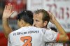 Bayern Munich's Harry Kane, right, celebrates scoring his second goal during the DFB Pokal, Germany Cup, soccer match, against SV Wehen Wiesbaden, Wednesday, Aug 27, 2025, in Wiesbaden, Germany. (Uwe Anspach/dpa via AP)