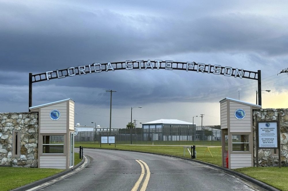 FILE - Clouds hover over the entrance of the Florida State Prison in Starke, Fla., Aug. 3, 2023. (AP Photo/Curt Anderson, File)