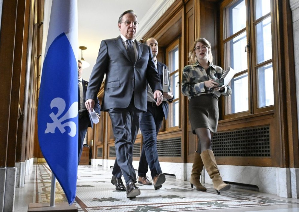 Quebec Premier François Legault, left, walks to a news conference prior to question period at the legislature in Quebec City, Tuesday, April 29, 2025. THE CANADIAN PRESS/Jacques Boissinot