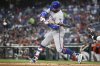 New York Mets Brandon Nimmo hits a RBI single during the third inning of a baseball game against the Washington Nationals Tuesday, Aug. 19, 2025, in Washington. (AP Photo/John McDonnell)