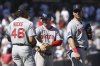 Boston Red Sox pitcher Jordan Hicks, left, third baseman Alex Bregman, center, and first baseman Nathaniel Lowe, right, react after defeating the New York Yankees in a baseball game Saturday, Aug. 23, 2025, in New York. (AP Photo/Pamela Smith)