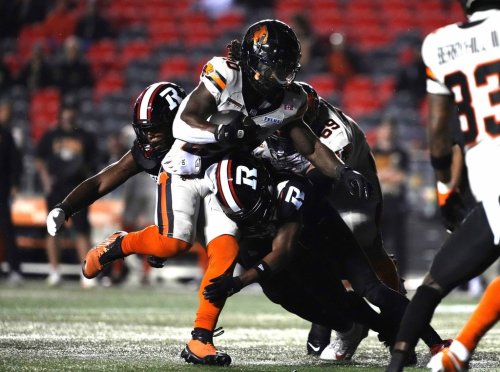 B.C. Lions running back James Butler (20) makes his way past Ottawa Redblacks defensive lineman Aidan John (93), before scoring a touchdown during first half CFL football action in Ottawa on Friday, Sept. 5, 2025. THE CANADIAN PRESS/Justin Tang