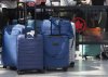 Luggage is seen as travellers wait in line at the Air Canada counter in Montreal-Pierre Elliott Trudeau International Airport in Dorval, Que., Friday, Aug. 15, 2025. THE CANADIAN PRESS/Christinne Muschi