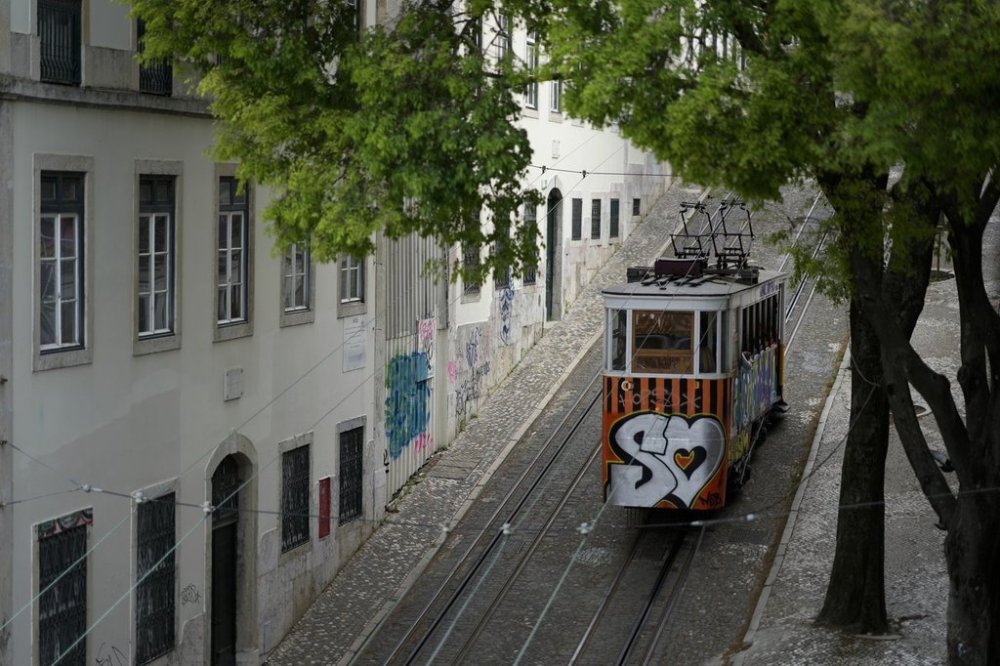 FILE - The Gloria funicular makes its way uphill in Lisbon, on April 12, 2023. (AP Photo/Armando Franca, File)