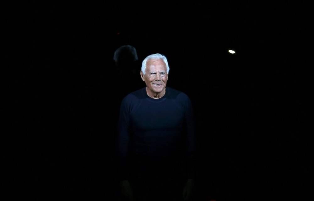 FILE - Italian fashion designer Giorgio Armani acknowledges applause at the end of his Emporio Armani men's Fall-Winter 2014 collection, part of the Milan Fashion Week, unveiled in Milan, Italy, Jan. 13, 2014. (AP Photo/Antonio Calanni, file)