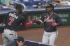Atlanta Braves' Jurickson Profar (7) congratulates Ozzie Albies after scoring a home run during the fourth inning of a baseball game against the Miami Marlins, Tuesday, Aug. 26, 2025, in Miami. (AP Photo/Marta Lavandier)
