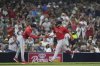 Boston Red Sox's Wilyer Abreu, right, celebrates his two-run home run with third base coach Kyle Hudson during the fourth inning of a baseball game against the San Diego Padres Friday, Aug. 8, 2025, in San Diego. (AP Photo/Gregory Bull)