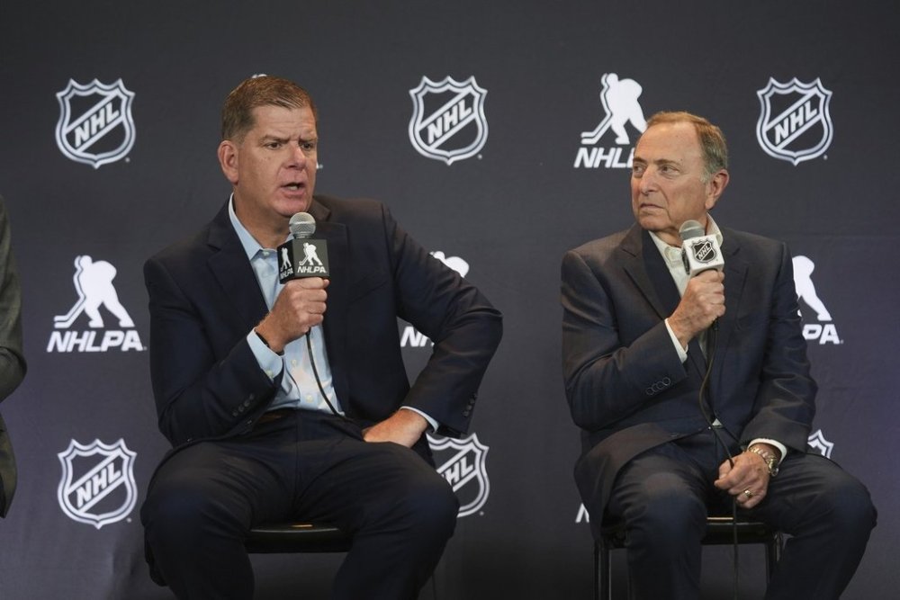 FILE - Marty Walsh, left, NHLPA Executive Director, and Gary Bettman, NHL Commissioner, conduct a joint news conference before the NHL hockey draft on June 27, 2025, in Los Angeles. (AP Photo/Damian Dovarganes, File)