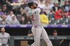 Arizona Diamondbacks' Lourdes Gurriel Jr. follows the flight of his three-run home run off Colorado Rockies starting pitcher Bradley Blalock in the first inning of a baseball game Thursday, Aug. 14, 2025, in Denver. (AP Photo/David Zalubowski)