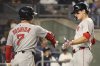 Boston Red Sox' Roman Anthony, right, reacts with teammate Masataka Yoshida, left, after scoring during the fifth inning of a baseball game against the New York Yankees, Thursday, Aug. 21, 2025, in New York. (AP Photo/Pamela Smith)