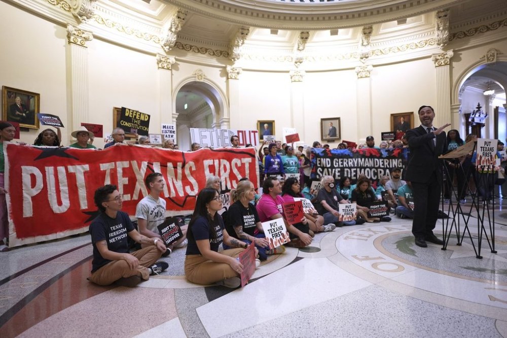 U.S. Congressman Joaquin Castro, right, speaks to protesters gather in the rotunda outside the House Chamber at the Texas Capitol as lawmakers debate a redrawn U.S. congressional map in Texas during a special, Wednesday, Aug. 20, 2025, in Austin, Texas. (AP Photo/Eric Gay)